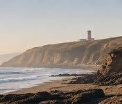 Cliffs and a lighthouse above a South Wales beach